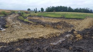 The core will only be constructed with clay. Here you can see the clay exposed beneath the pond, which we are bringing up to the core.